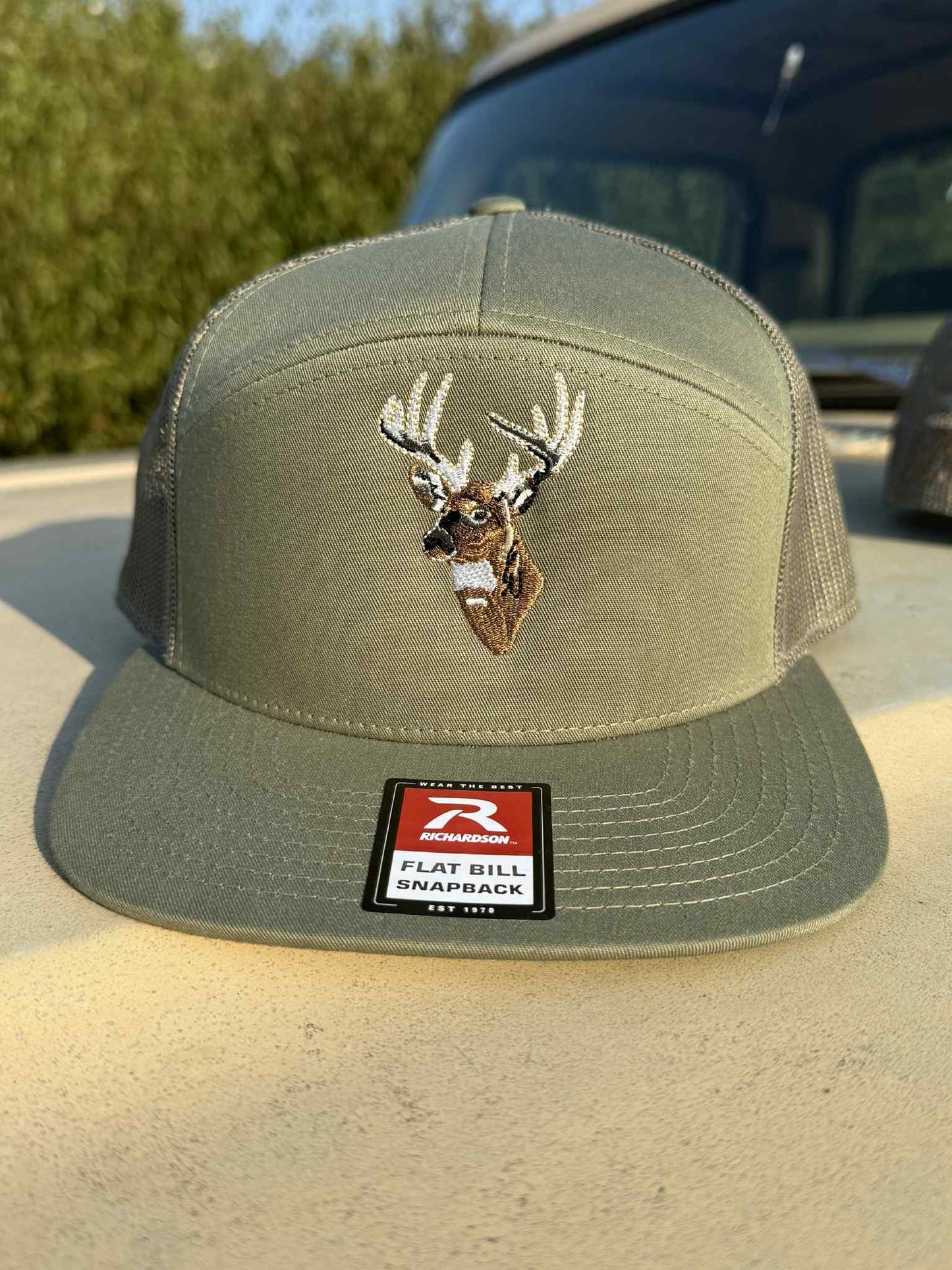 Olive green Richardson flatbill snapback hat with embroidered whitetail buck, King Of The Timber design