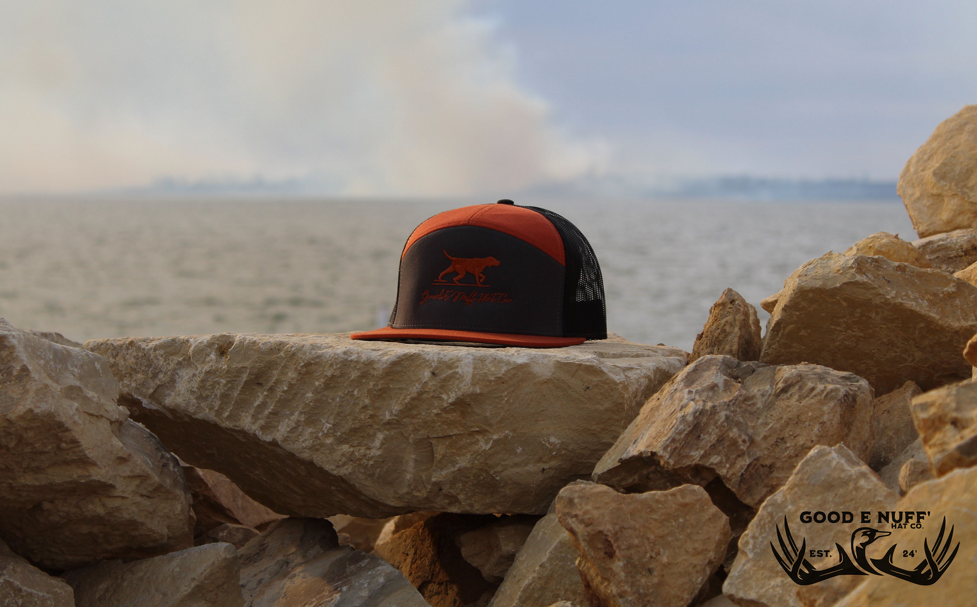 Copper Point and Shoot hat with embroidered dog and GEN script, charcoal front, copper-orange brim, and mesh back.