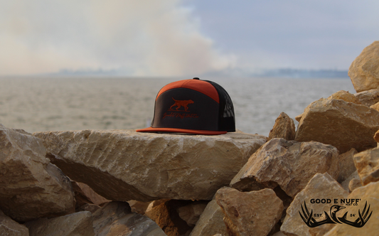 Copper Point and Shoot hat with embroidered dog and GEN script, charcoal front, copper-orange brim, and mesh back.
