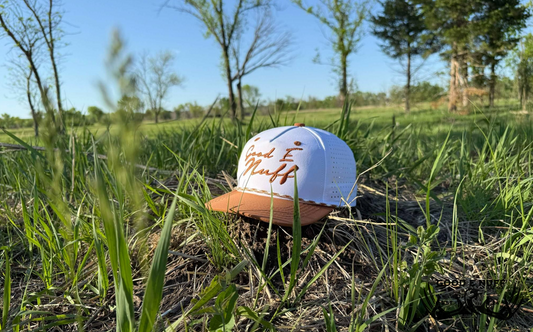 Dusk til’ Dawn cap with breezy mesh and classic rope brim in a grassy field.