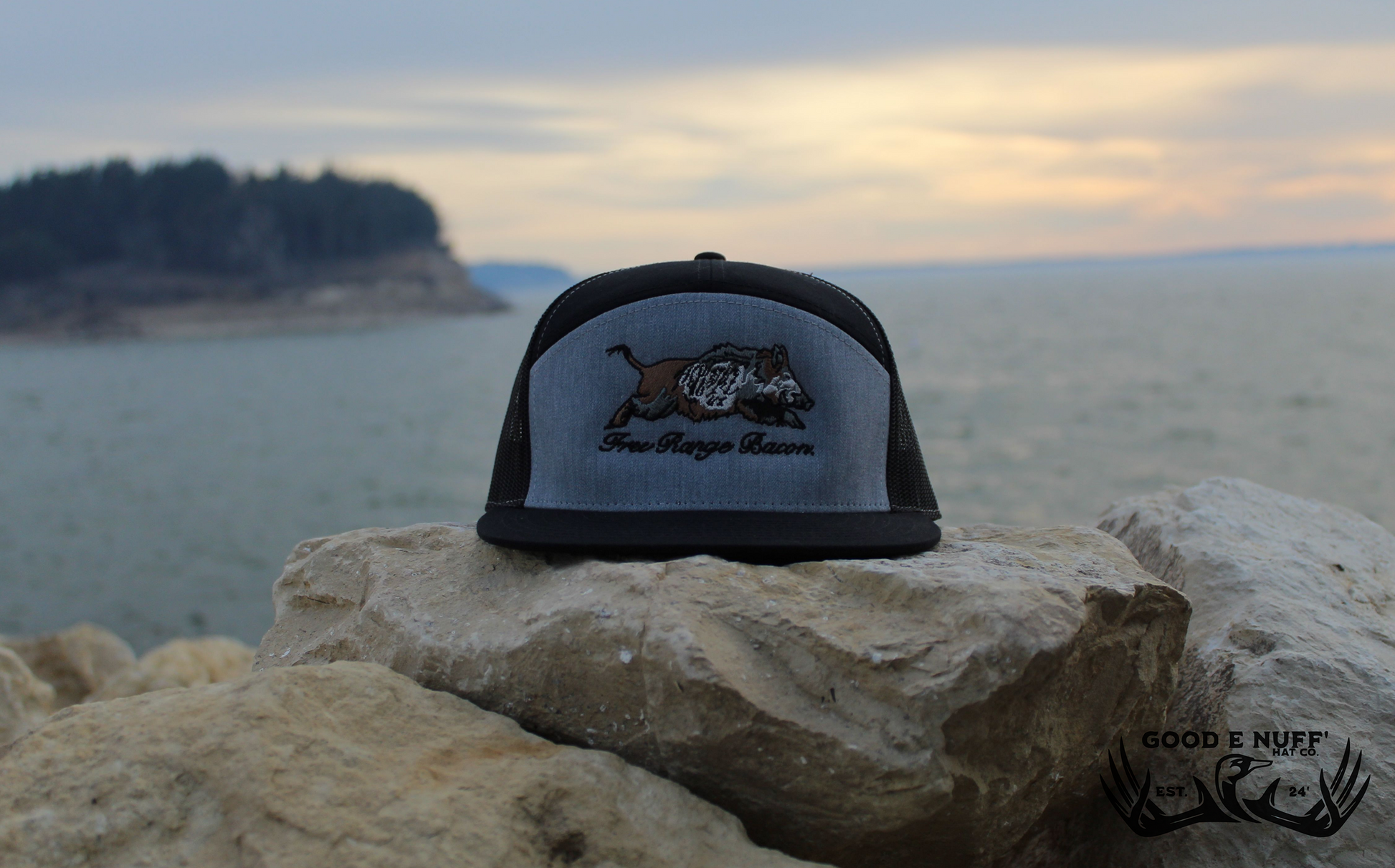 Free Range Bacon gray and black snapback hat with embroidered wild hog graphic on rocks by water