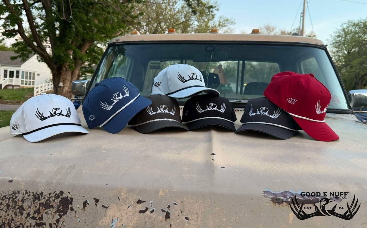 Classic 2.0 hats with antler embroidery on truck hood, various colors.