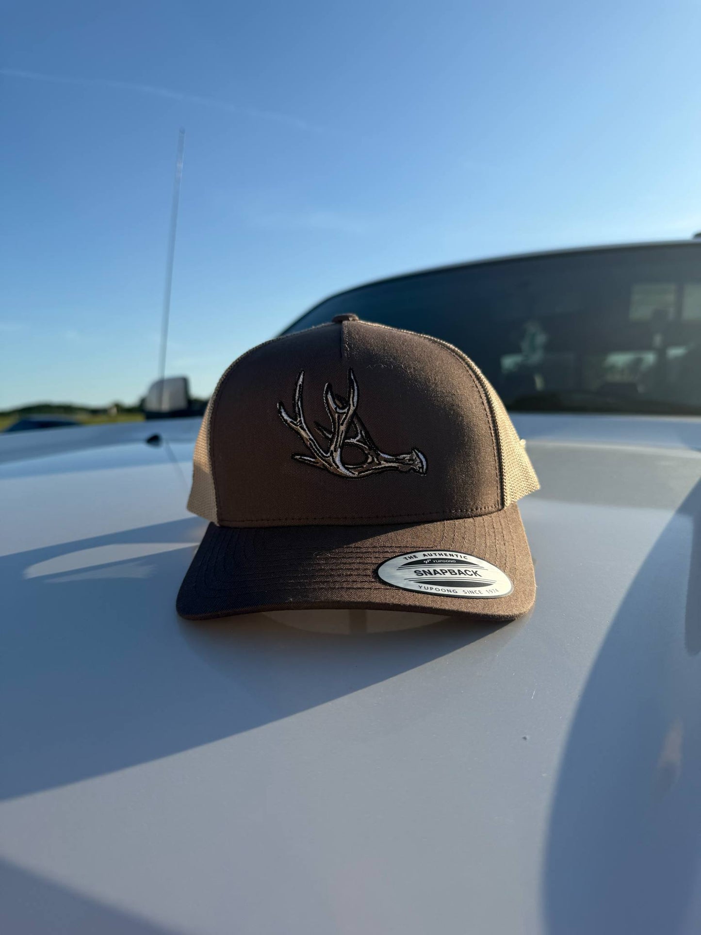 No Velvet brown and tan Yupoong snapback hat with embroidered hard horn antler design