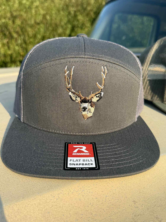 King of the Pines charcoal flat bill snapback hat with embroidered mule deer buck design