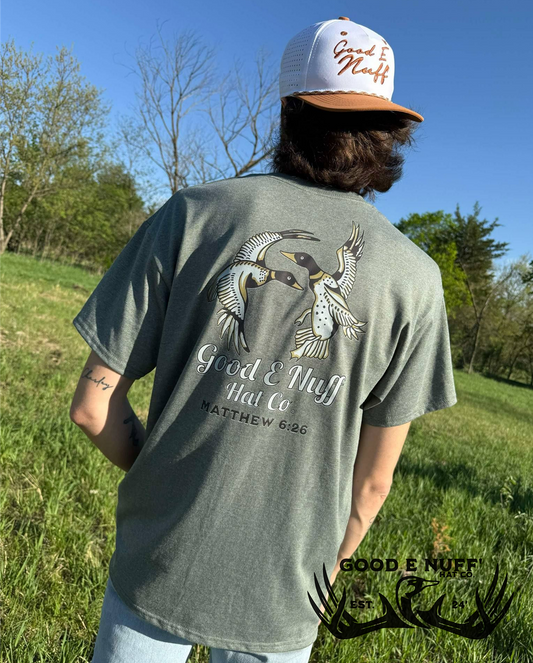 The Provider t-shirt featuring ducks in flight and Matthew 6:26, worn outdoors.