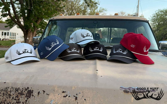 Classic 2.0 hats with antler embroidery on truck hood, various colors.