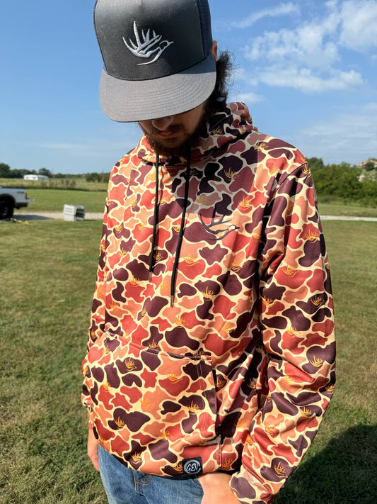 Man wearing Good E Nuff' Camo Hoodie with custom GEN camouflage, extra-large hood, and fleece lining outdoors.